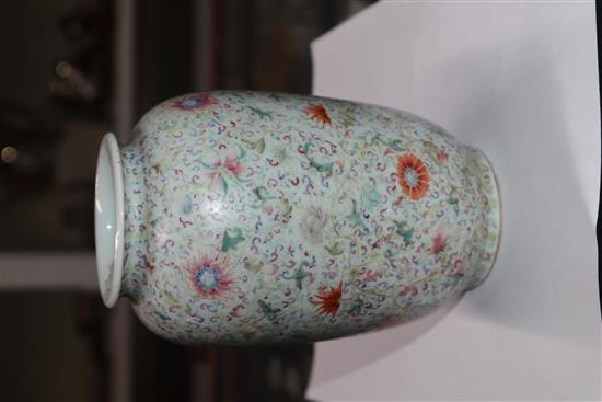 A Chinese famille rose ovoid vase, Qing dynasty, finely painted with flowers and scrolling foliage, H. 15cm, drilled hole to side of ba